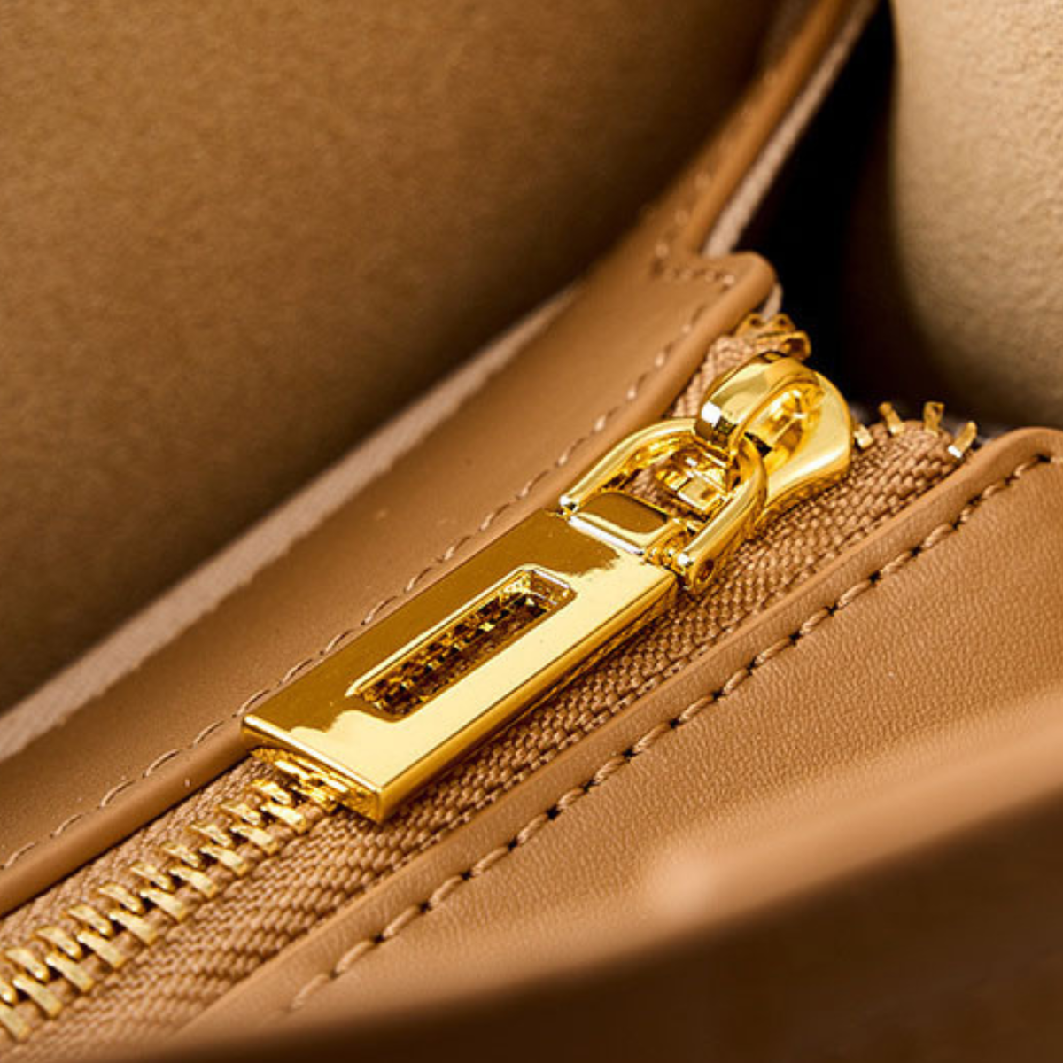 Tan leather tote bag zipper with gold hardware