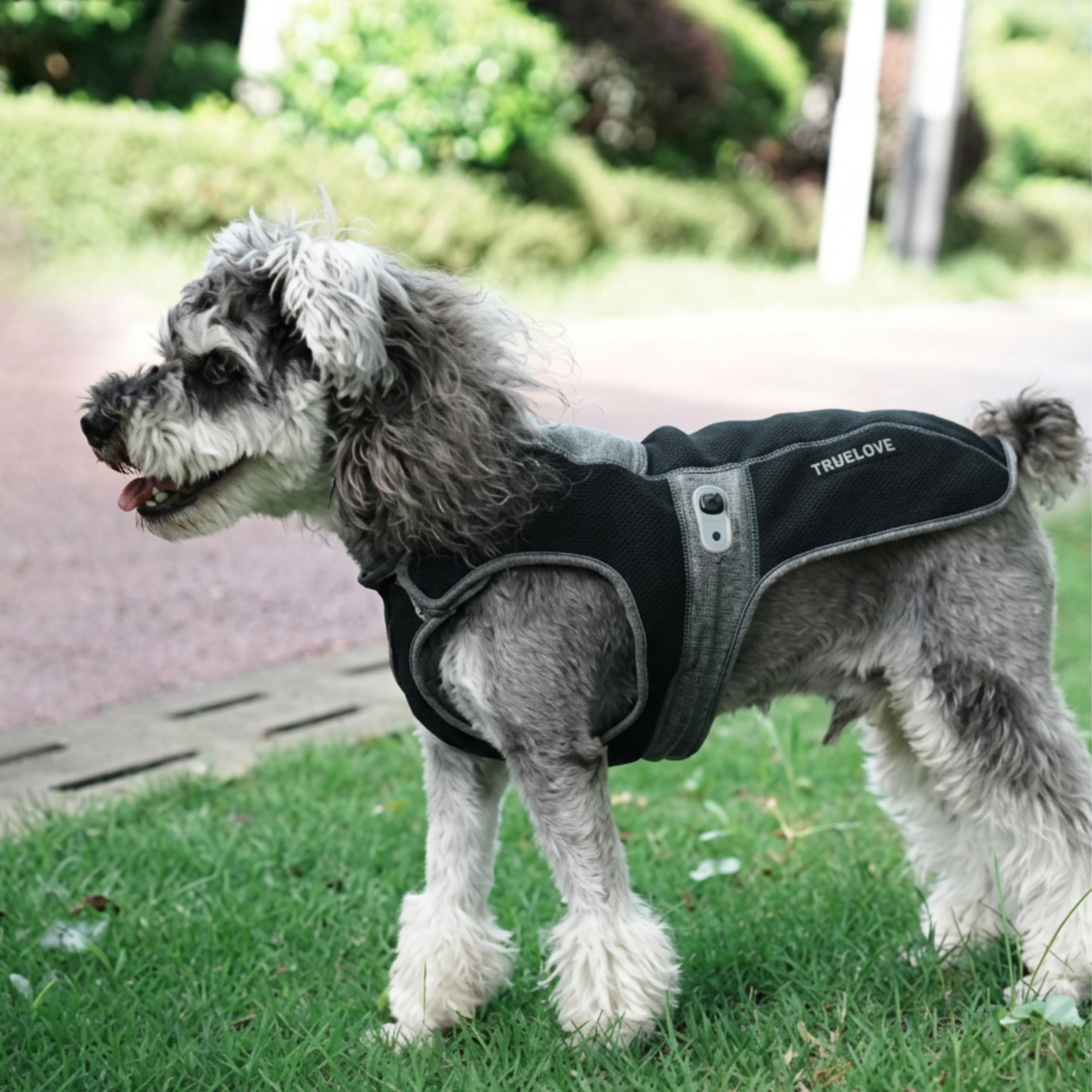 Truelove black fleece dog jacket with velcro attachments, adjustable strings and reflective logo