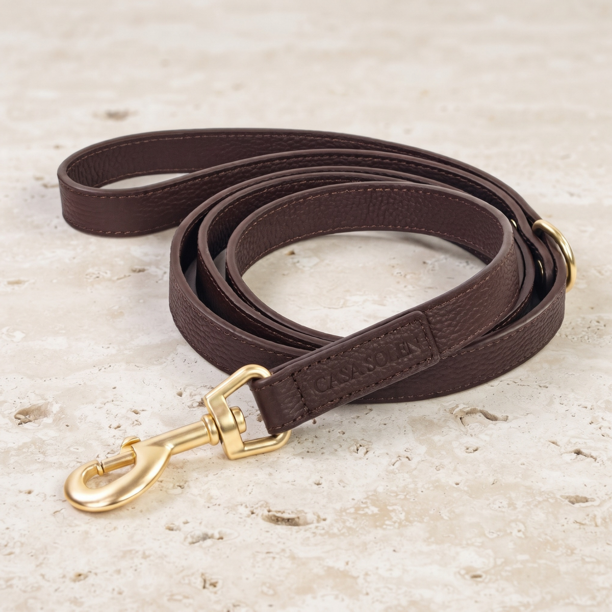 Leather dog leash in chestnut brown with matte gold swivel clips and embossed logo