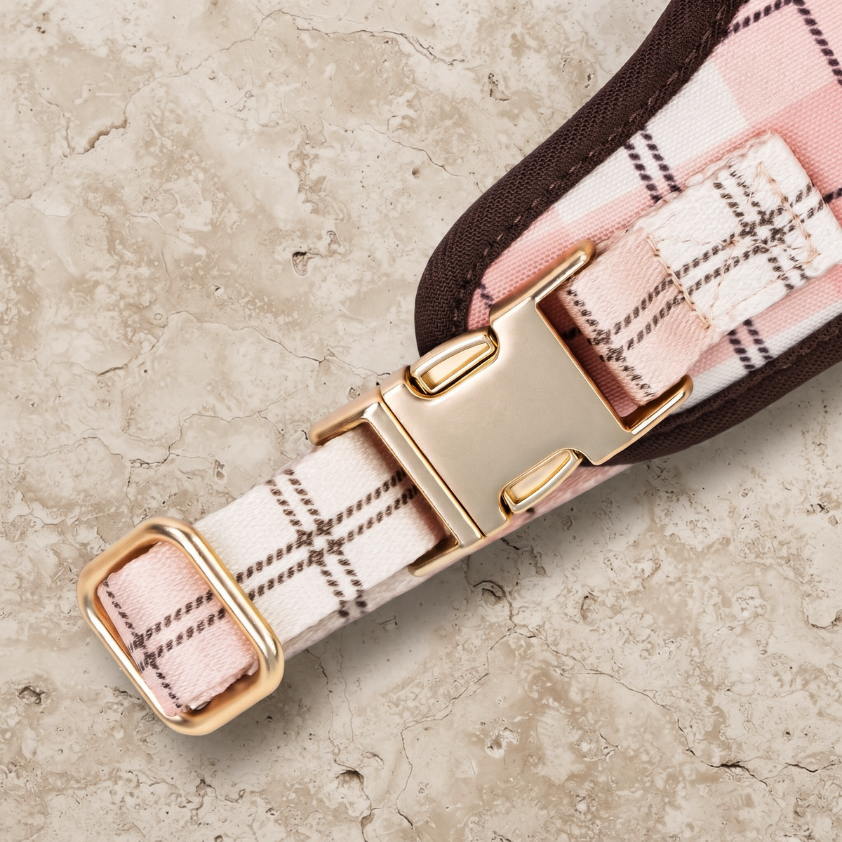 Plaid dog harness close-up with two gold-tone buckle straps and adjustable rings
