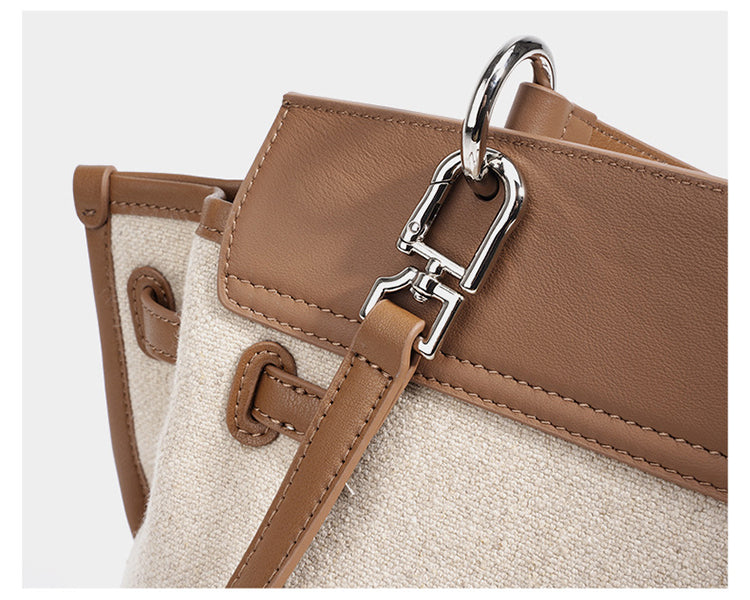 Oat and cognac leather bag side with stitched trim and metal D-ring strap