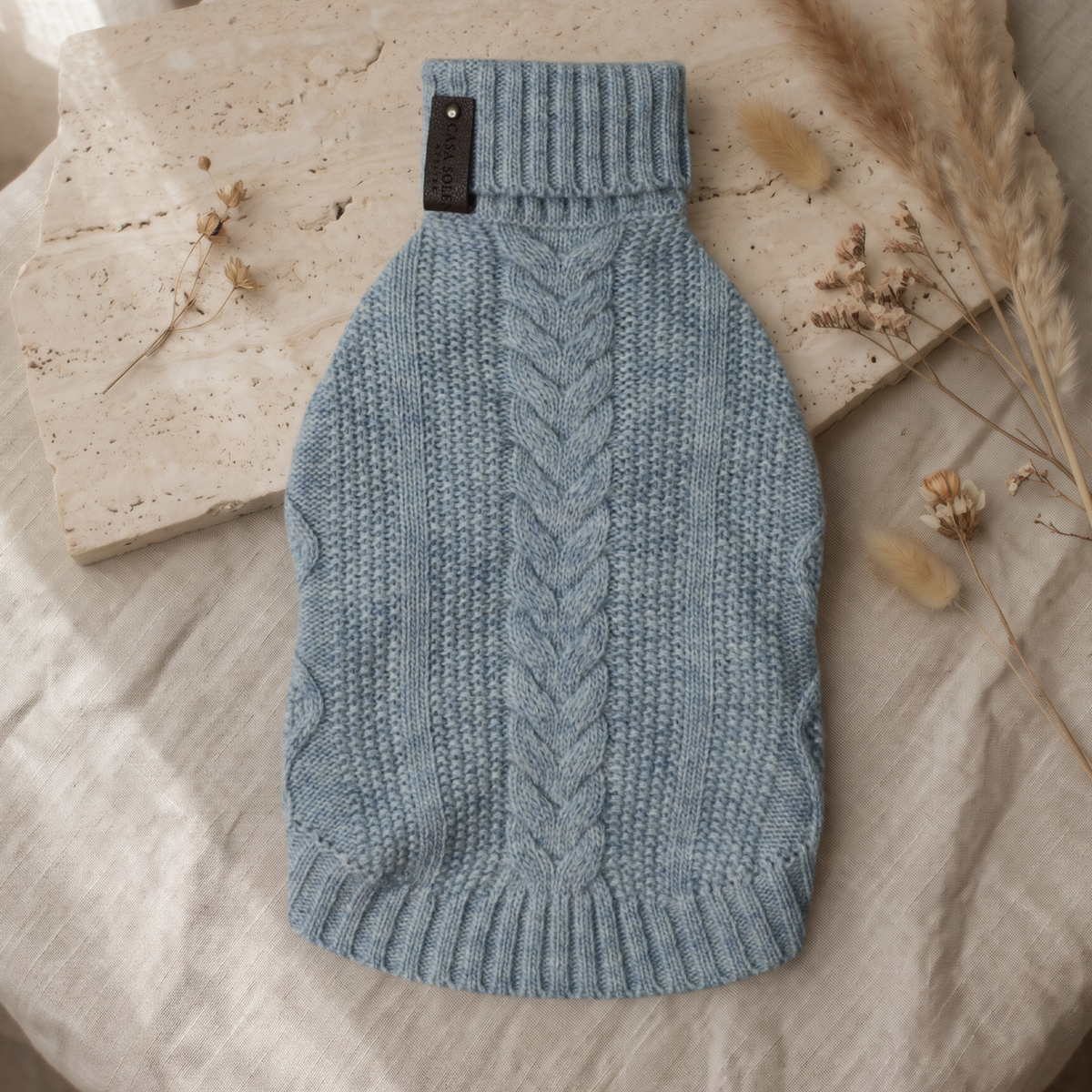Blue knitted wool pet sweater with ribbed turtleneck and cable-knit front