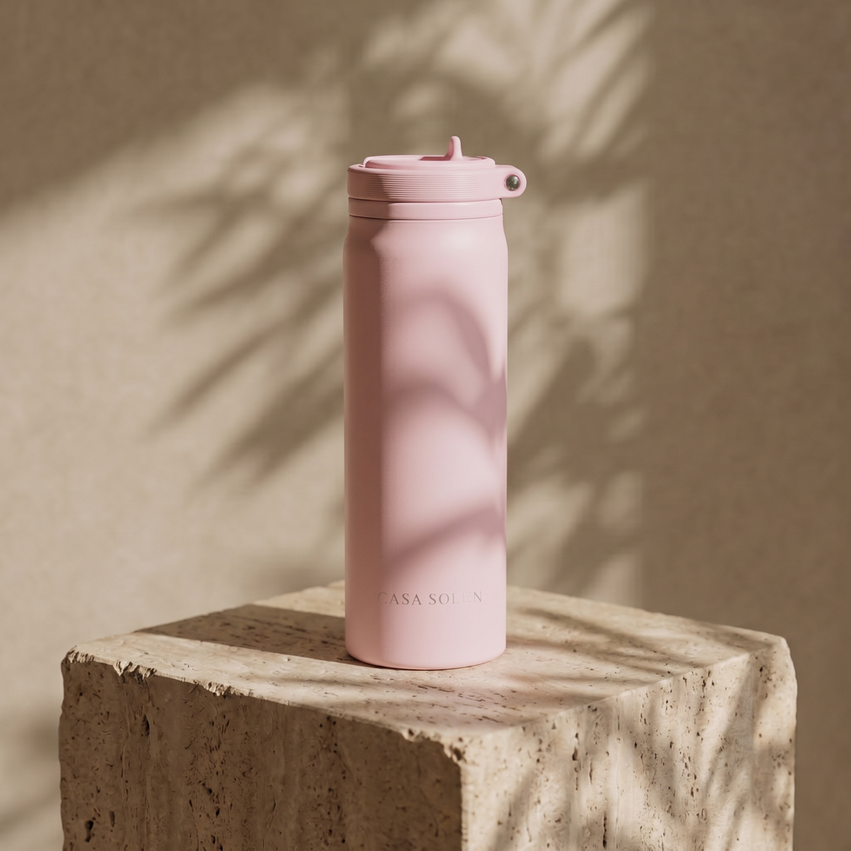 Powder blush pink insulated bottle with screw-top lid and carry handle loop