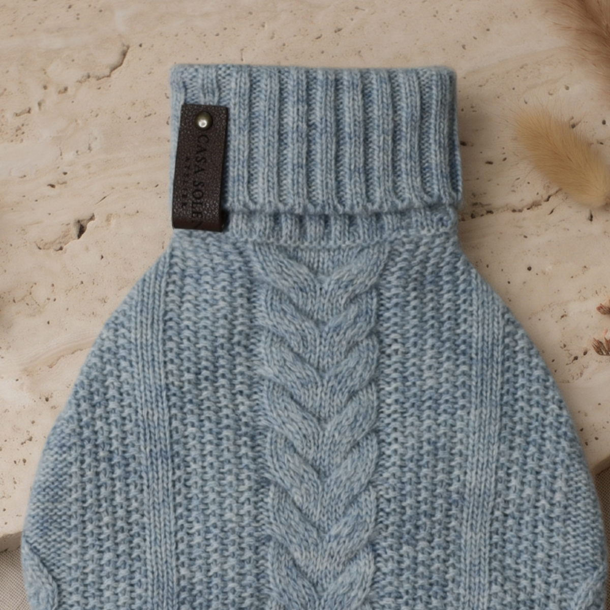 Blue knitted pet sweater with ribbed collar and signature logo