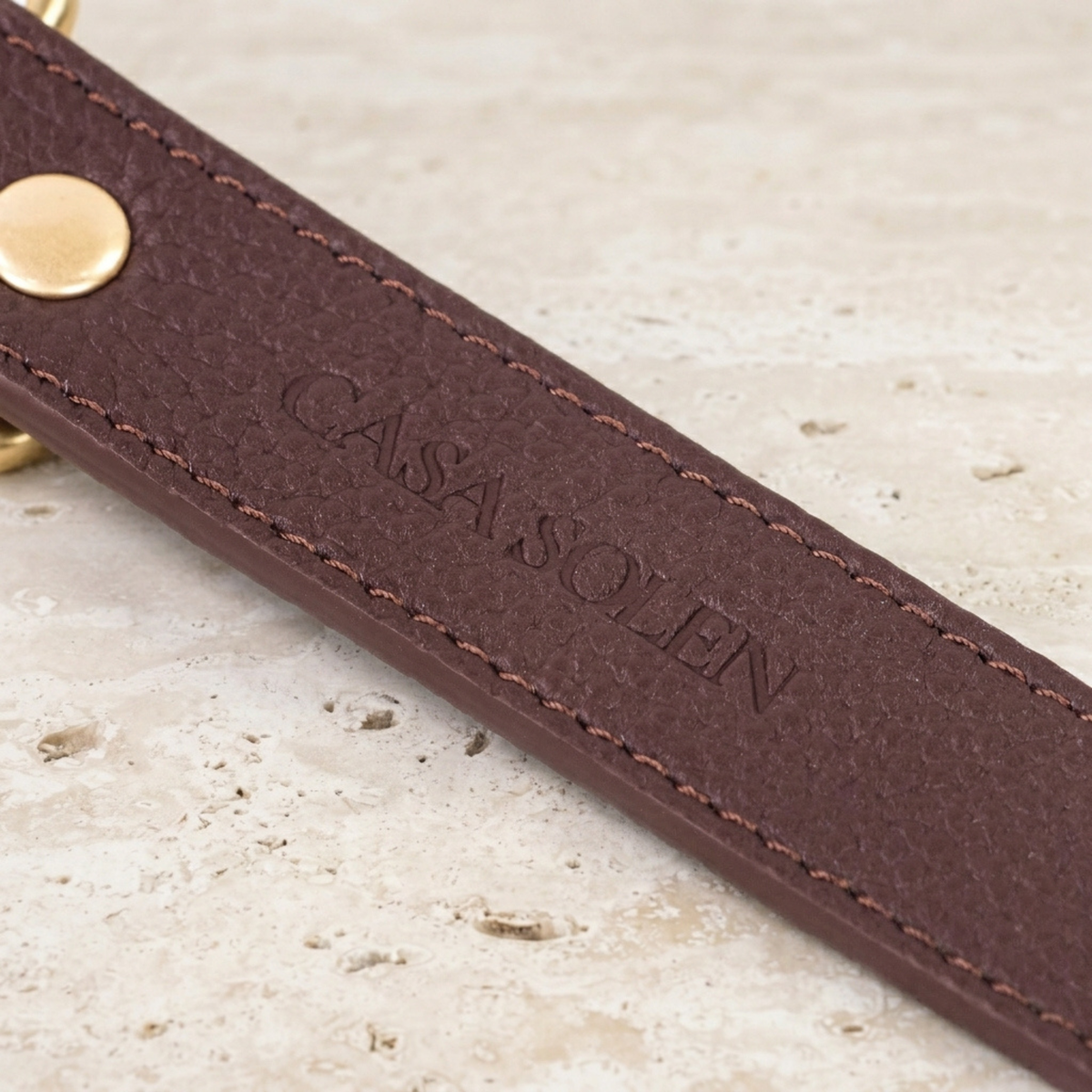 Chestnut leather collar strap with embossed Casa Solen Atelier branding