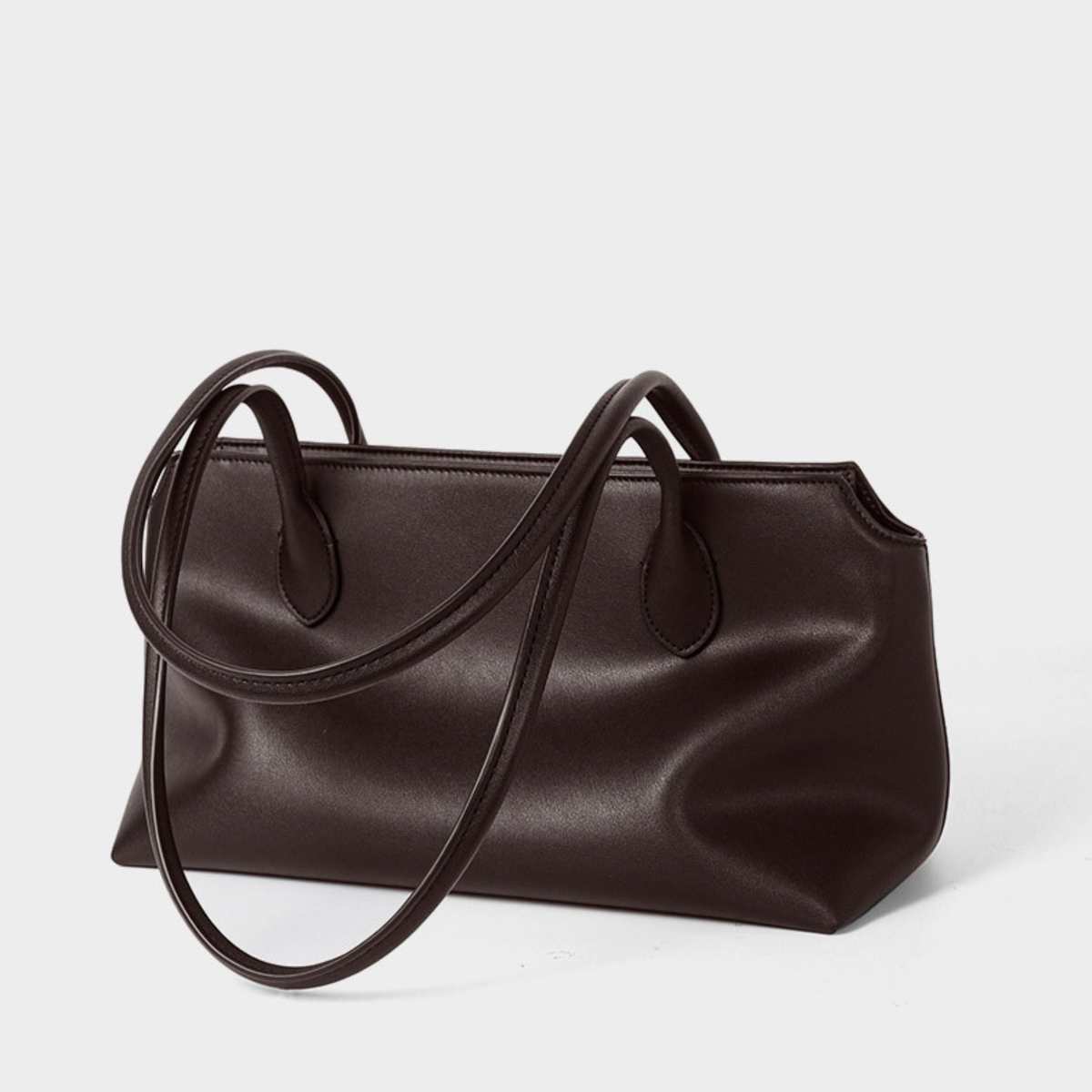 Brown leather tote bag with long shoulder handles, smooth structured front