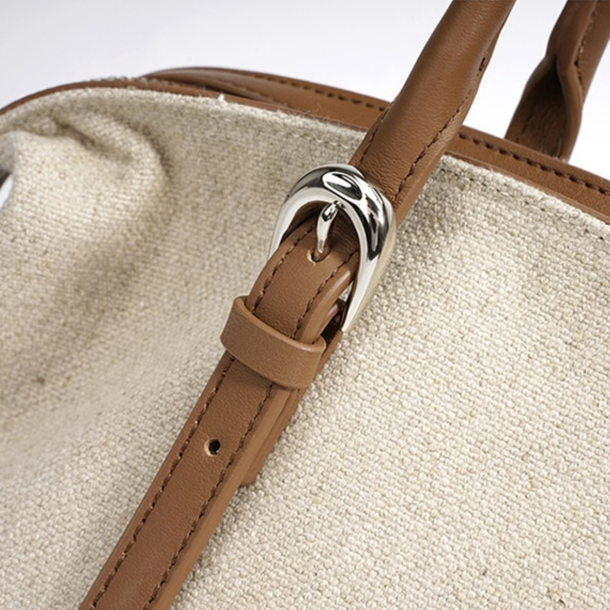 Cognac leather strap loop with metal ring on oat canvas tote