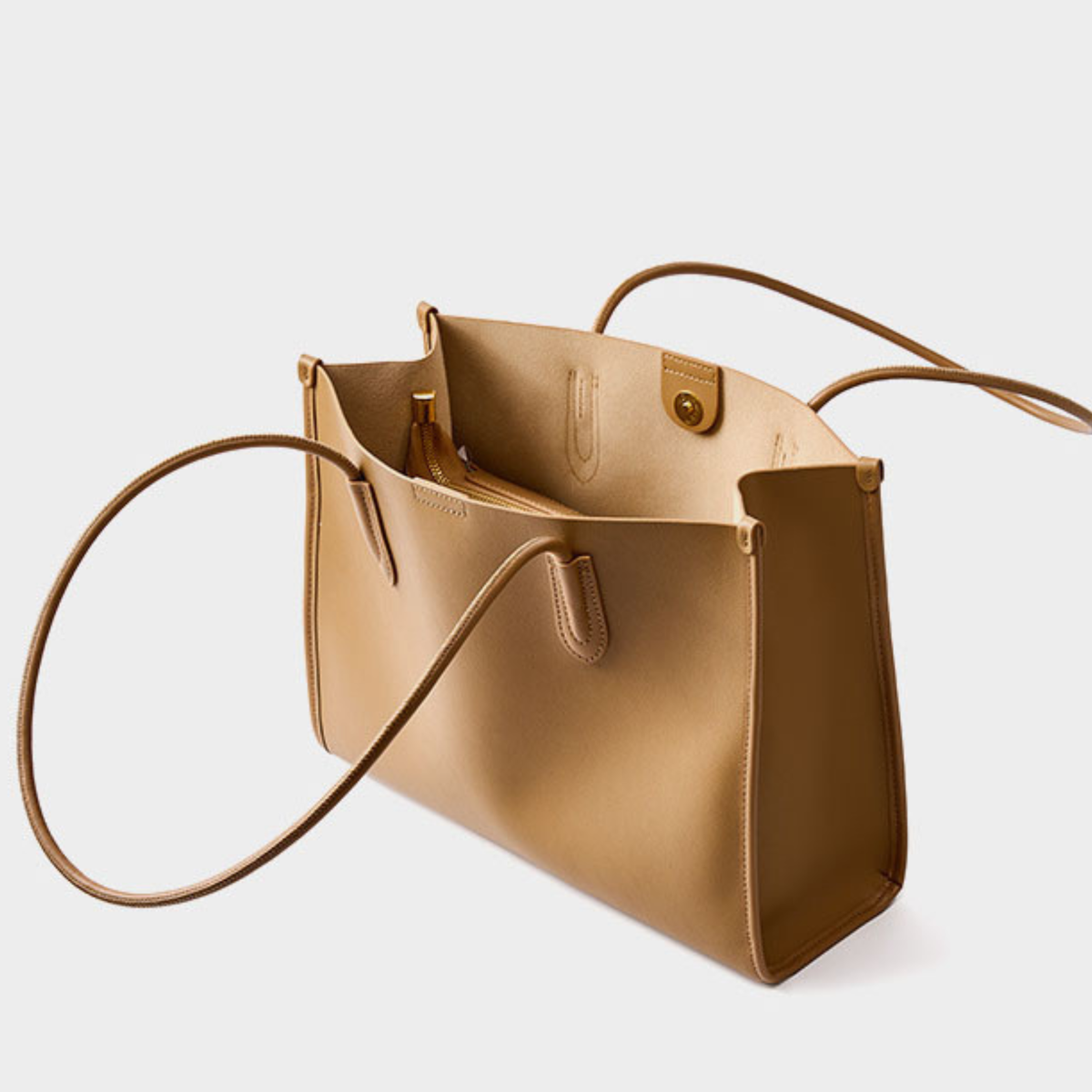 Tan leather tote bag open with inner pocket